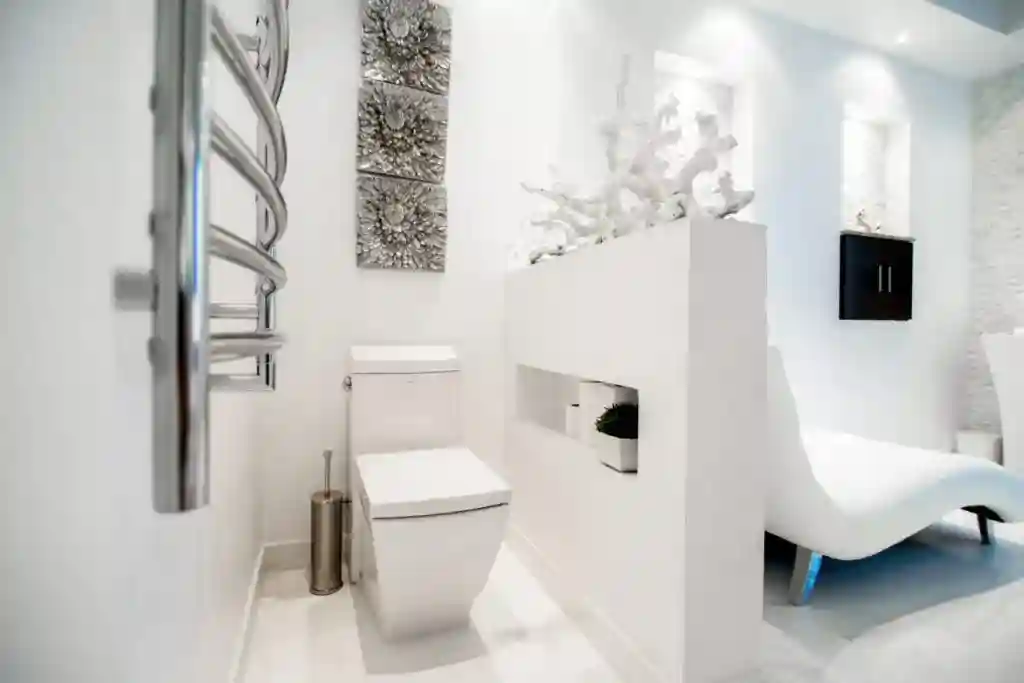 Walk-in shower with glass enclosure and tile walls